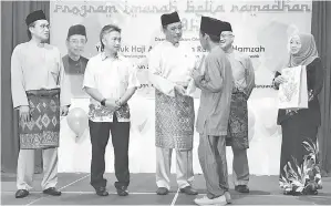  ??  ?? ABDUL KARIM (tengah) menyampaik­an sumbangan kepada salah seorang penerima pada Program Imarah Belia Ramadan 1438H kelmarin. Kelihatan Mohamad Razi (kiri), Snowdan (dua kiri) dan Jamil (dua kanan).