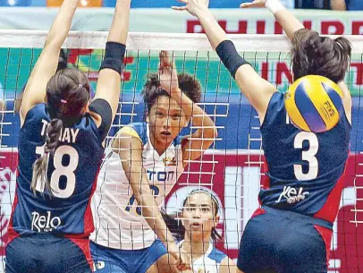  ?? JUN MENDOZA ?? Faith Torres of Foton (13) defies Petron’s Carmela Tunay and Mika Reyes’ defense to score on a hit during their Superliga clash yesterday.