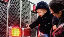  ?? (Photo by Logan Kirkland, SDN) ?? One-year-old Ben Winer and his mother Kate McClellan touch one of the Oktibbeha County Fire Department trucks at Volunteer Starkville’s sixth-annual Touch-A-Truck event on Saturday at the Sportsplex.