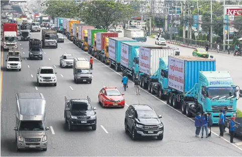  ?? SOMCHAI POOMLARD ?? Lorries are seen parked along Bang Na-Trat Road during the ‘Truck Power’ protest yesterday. Protesting truckers are demanding diesel prices be reduced and maintained at 25 baht a litre to offset soaring transport costs.