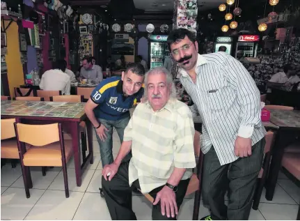  ?? Jeffrey E Biteng / The National ?? Mohammed Ansari, owner of Special Ostadi, with his two of his four sons, Taleb Ansari, left, and Majeed Ansari. The 83-year-old who came to Dubai after being displaced by the Second World War died last week in Iran’s Shiraz because of kidney failure.