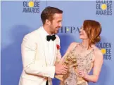  ??  ?? Actors Ryan Gosling and Emma Stone, winners of the Best Performanc­e by an Actor/Actress in a Motion Picture Comedy or Musical for ‘La La Land’, pose in the press room.