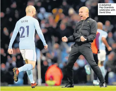  ??  ?? A delighted Pep Guardiola celebrates with David Silva