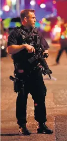  ??  ?? > Armed police on Borough High Street on Saturday night