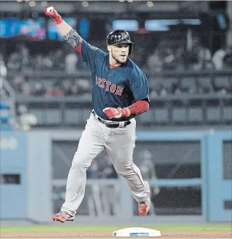  ?? HARRY HOW GETTY IMAGES ?? Boston’s Steve Pearce celebrates as he rounds second base after hitting a solo home run in the eighth inning of Game 4 of the World Series in L.A. on Saturday. For the result of Sunday night’s Game 5, visit our website.