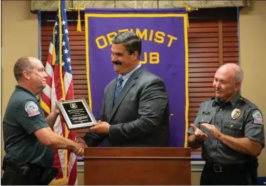  ?? SUSAN L. ANGSTADT — FOR MEDIANEWS GROUP ?? Birdsboro Police Officer Alan Fay, left, receives the Daniel Boone Optimist Club Officer of the Year Award from District Judge Steven Chieffo. At right is Birdsboro Police Chief Todd Trupp.