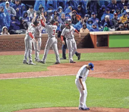  ?? ASSOCIATED PRESS ?? Michael A. Taylor and Nationals teammates celebrates his grand slam off Cubs relief pitcher Wade Davis in the eighth inning.