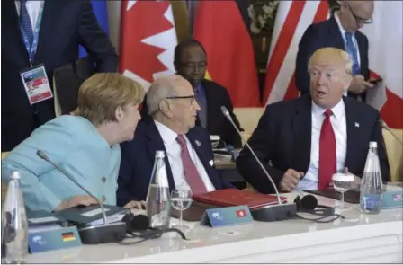  ?? FLAVIO LO SCALZO — ANSA VIA AP ?? US President Donald Trump shares a word with German Chancellor Angela Merkel, left, as Tunisia’s President Beji Caid Essebsi listens, at a G7 Summit expanded session, in the Sicilian town of Taormina, Italy, Saturday.