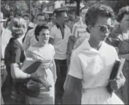  ?? WILL COUNTS — ARKANSAS DEMOCRAT-GAZETTE VIA AP, FILE ?? In this file photo, students of Central High School in Little Rock, Ark., including Hazel Bryan, shout insults at Elizabeth Eckford as she calmly walks toward a line of National Guardsmen. The Guardsmen blocked the main entrance and would not let her...