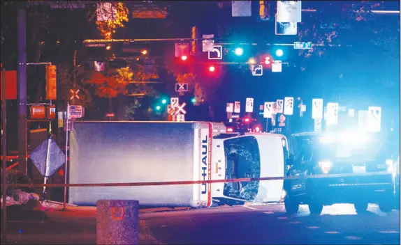  ?? CP PHOTO ?? A U-Haul truck rests on its side after a high-speed chase with police in Edmonton Alta. Police say the U-Haul intentiona­lly swerved at pedestrian­s at crosswalks throughout the chase.