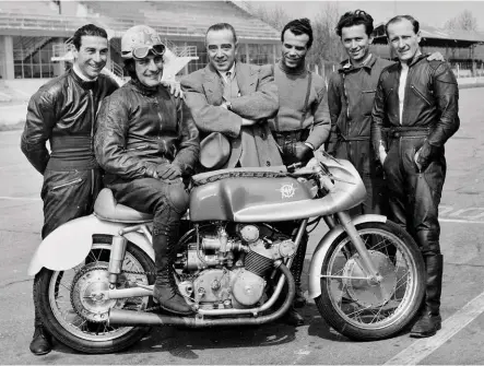  ??  ?? Left: Count Agusta joins the team during testing at Monza in 1952. By this time, the MV 500 four-cylinder machine had been converted from its original shaft to chain final drive. Carlo Bandirola is seated on the bike, with British rider and 1949 500cc World Champion Les Graham far right