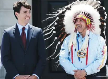  ?? SEAN KILPATRICK/THE CANADIAN PRESS FILES ?? Prime Minister Justin Trudeau and Perry Bellegarde, national chief of the Assembly of First Nations. In 2015, Trudeau said First Nations “should not have to wait one more day for … critical resources,” but his words haven’t been matched by action, says...