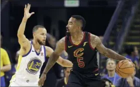  ?? MARCIO JOSE SANCHEZ — THE ASSOCIATED PRESS ?? Cleveland Cavaliers guard J.R. Smith (5) is defended by Golden State Warriors guard Stephen Curry (30) during the first half of Game 1 of basketball’s NBA Finals in Oakland, Calif. Thursday.