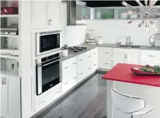  ?? CORIAN DESIGN ?? The central countertop in Corian’s Royal Red gives a vibrant jolt of colour to this white kitchen.