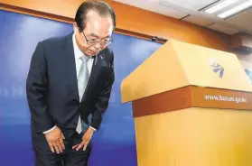  ?? Yonhap / AFP / Getty Images ?? Mayor Oh Keodon bows before cameras during a news conference on his resignatio­n at city hall in Busan, South Korea’s secondlarg­est city.