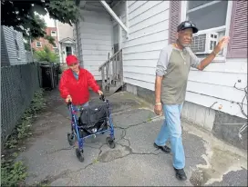  ?? JULIA MALAKIE / LOWELL SUN ?? Ismael Rodriguez and Margarita Garcia Lozada, both then 74, go for one of their daily walks down Broadway in Lowell in June 2019.