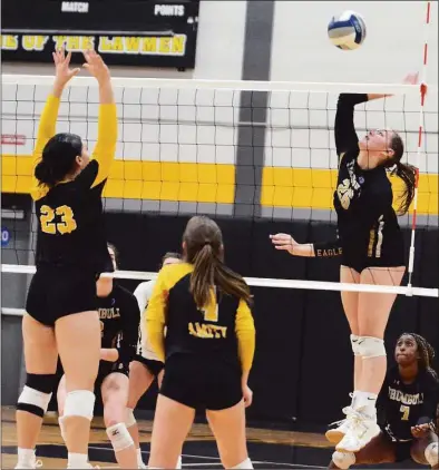  ?? Dave Phillips / For Hearst Connecticu­t Media ?? Trumbull’s Camdyn Roth (26) sends the ball over the net. Vivian Cain (23) and Sabrina McGovern (4) of Amity defend in Wednesday’s CIAC Class LL semifinal.