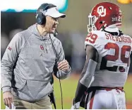  ?? [NATE BILLINGS/ THE OKLAHOMAN] ?? OU head coach Lincoln Riley talks to Rhamondre Stevenson (29) during last season's Bedlam victory in Stillwater.