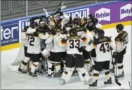  ?? MARTIN MEISSNER — THE ASSOCIATED PRESS ?? German players mob goalkeeper Thomas Greiss after defeating the United States, 2-1, in the World Championsh­ips on Friday.