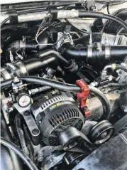  ??  ?? We love it when a plan comes together! That fresh turbocharg­er with some hightemp coating on the exhaust housing looks so good with our black wrinkle coat piping. You’d never know this was a 231,000 truck, the engine bay really came together nicely on this build.