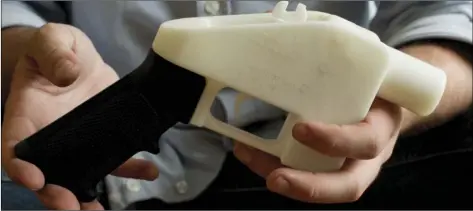  ?? JAY JANNER/AUSTIN AMERICAN-STATESMAN VIA AP ?? In this May 10, 2013, file photo, Cody Wilson holds what he calls a Liberator pistol that was completely made on a 3-D-printer at his home in Austin, Texas. Eight states filed suit on Monday, against the Trump administra­tion over its decision to allow...