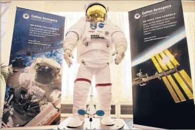  ?? PATRICK RAYCRAFT/HARTFORD COURANT ?? At the two-day Internatio­nal Space Summit, a Collins Aerospace spacesuit stands on display in the upstairs lobby at the Marriott Downtown Hartford.