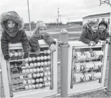  ?? SHARON MONTGOMERY • CAPE BRETON POST ?? Friends at the Marica Fiolek Memorial Playground in Dominion on Thursday, from left, Levon Pratt, 3 and Ophelia Pratt, 5, of Dominion and Abby May Comer, 3, and Jaydan Mackinnon, 4, of Glace Bay, have fun on some of the older equipment at the park.