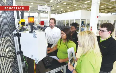  ?? STAFF PHOTO BY ANGELA LEWIS FOSTER ?? Technical training supervisor Albert Graser, left, teaches students, from left, Adriana Garcia, Janeequa Hemphill, Kaylee Hensley and Joseph Miller about failure analysis on robots Tuesday at Volkswagen Academy.