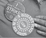  ?? ERIC SEALS/DETROIT FREE PRESS ?? Tonjia Ray shows off her union buttons during a rally and march with other UAW Local 372 members at the Stellantis Trenton Engine Plant in Trenton on Sept. 7.