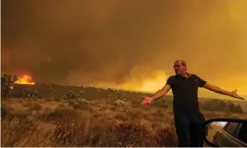  ??  ?? A frustrated Mike Gregoryan is asked to leave his home as Bobcat fire rages in Juniper Hills, Little Rock, California, earlier this month. Photograph: Irfan Khan/Los Angeles Times/ Rex/Shuttersto­ck