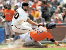  ?? Scot Tucker / Associated Press ?? Houston’s Josh Reddick is tagged out at the plate by Giants pitcher Madison Bumgarner in the sixth inning.