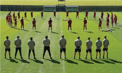  ??  ?? The Liverpool team and backroom staff observing a 97-second silence for Andrew Devine. Photograph: John Powell/Liverpool FC/Getty Images