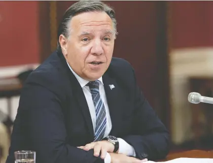  ?? JACQUES BOISSINOT/THE CANADIAN PRESS ?? “Given the emergency of the pandemic, the exceptiona­l situation (we were in), we chose to go further than what is foreseen in the laws and regulation­s” regarding communicat­ion with the English-speaking community, says Premier François Legault.