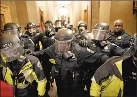  ?? Kent Nishimura Los Angeles Times ?? POLICE CLEAR a hallway inside the U.S. Capitol during the Jan. 6 insurrecti­on.
