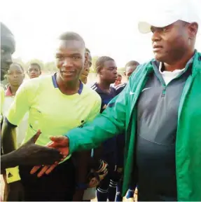  ??  ?? Chairman Kano State Football Associatio­n and NFF Executive Committee member, Alhaji Sharif Rabiu Inuwa (r) shaking hands with referees before the finals of a grassroot football tournament in Kano.
