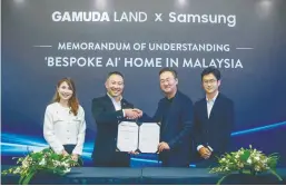  ?? ?? From left: Gamuda Land COO Jess Teng, Chu, Denny Kim, and Samsung Malaysia Electronic­s digital appliances business director Josh Kim at the MoU signing ceremony.