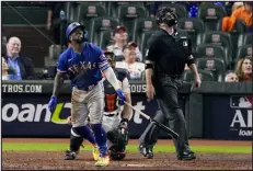  ?? TONY GUTIERREZ — THE ASSOCIATED PRESS ?? Texas Rangers’ Adolis Garcia hits a home run during the eighth inning of Game 7 of the ALCS against the Houston Astros on Monday in Houston.