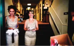  ??  ?? Photo provided by Serena Markstrom Nugent, bridesmaid­s Shanti Markstrom, left, sister of bride, and Angela Bennett (now Angela Jaquette) distribute wings prior to the wedding ceremony, in Eugene, Ore.