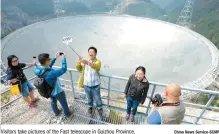  ?? China News Service-SCMP ?? Visitors take pictures of the Fast telescope in Guizhou Province.