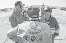  ??  ?? R.B. Kelley (center) flew 35 missions as a B-17 ball turret gunner. Kelley was among several WWII veterans recognized during a ceremony in Conroe.