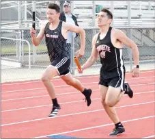  ??  ?? Blackhawk sophomore runner Sebasttien Mullikin races against the Gravette runner during one leg of a relay race Friday, April 9.