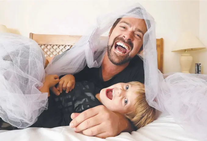  ?? Picture: RICHARD GOSLING ?? Comedian Shane Vincent, pictured with his son Knox Vincent, is laughing all the way up the aisle after making a successful transition to celebrant.