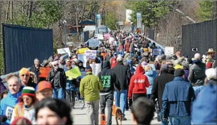  ?? PHOTO BY TONY ADAMIS ?? Mid-Hudson residents participat­e in the March for Our Lives on the Walkway over the Hudson on Saturday.