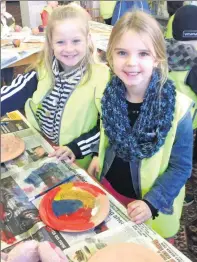  ??  ?? Madelynn Price and Addison Clarke at Finley library.
