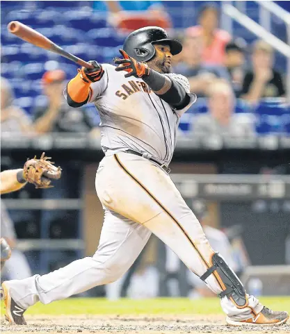  ??  ?? The Giants’ Pablo Sandoval hits a go-ahead 2-RBI single in the 16th inning against the Marlins.
