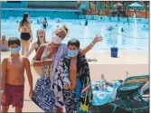  ?? (Courtesy Photo/Dalton Fischer, SDC) ?? Season ticket holders Sara Denny and twins Kade and Kendall of Branson sport their masks on one of the first days at White Water this season.