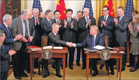  ?? WANG YING / XINHUA ?? Vice-Premier Liu He and United States President Donald Trump shake hands after signing the China-US phase-one trade deal at the White House on Wednesday.