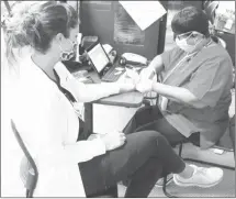  ?? Brodie Johnson • Times-Herald ?? The American Red Cross Blood Drive at the Forrest City Medical Center saw donations from area residents as well as hospital employees. ER Nurse Jamie Tracy has her iron checked by Karen Sides before her donation.