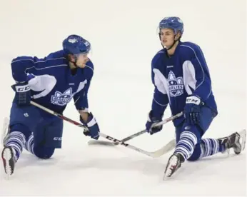  ?? RICHARD LAUTENS/TORONTO STAR ?? Tobias Lindberg, left, chats with his new teammate William Nylander during a Marlies practice on Wednesday.