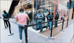  ?? MARY ALTAFFER/AP ?? Black Friday shoppers wait in line to enter the Nike store Friday in New York.
